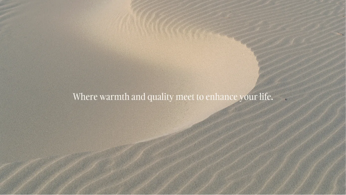 Carlton Shores tagline shot — where warmth and quality meet to enhance your life — on rippled sand
