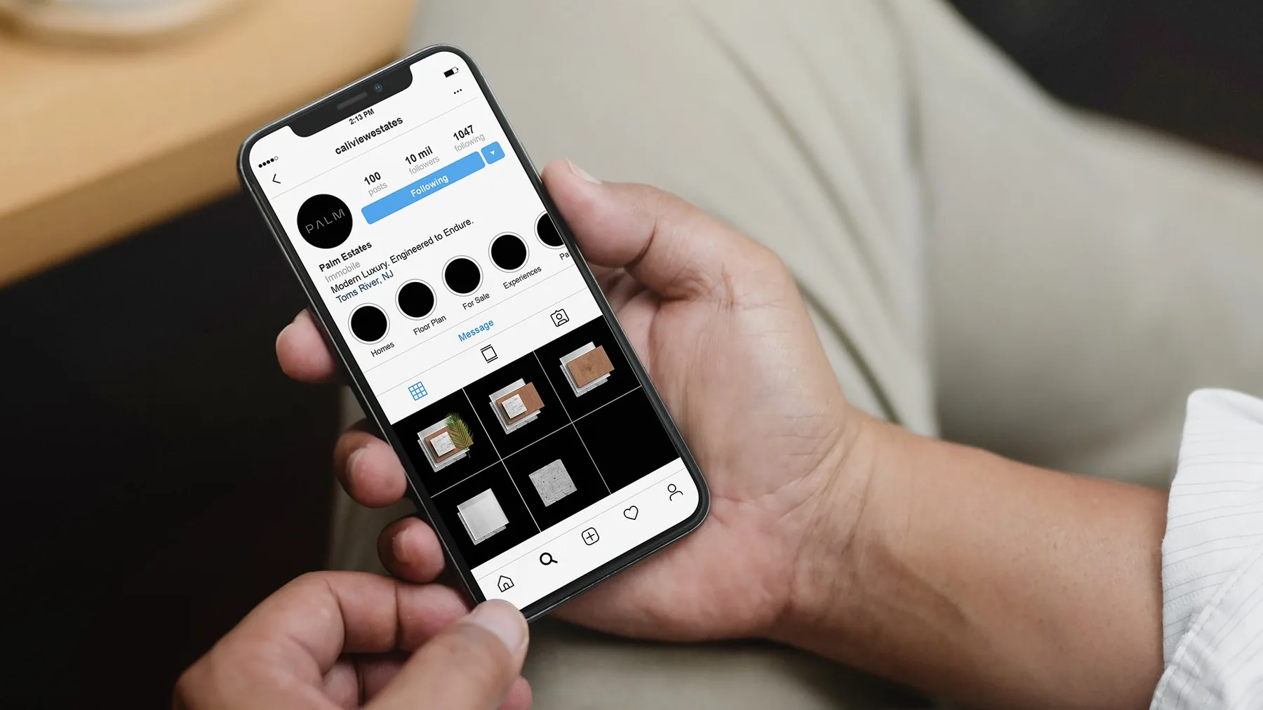 Palm Estates Instagram profile shown on a phone in a buyer’s hand — grid of brand and materials posts