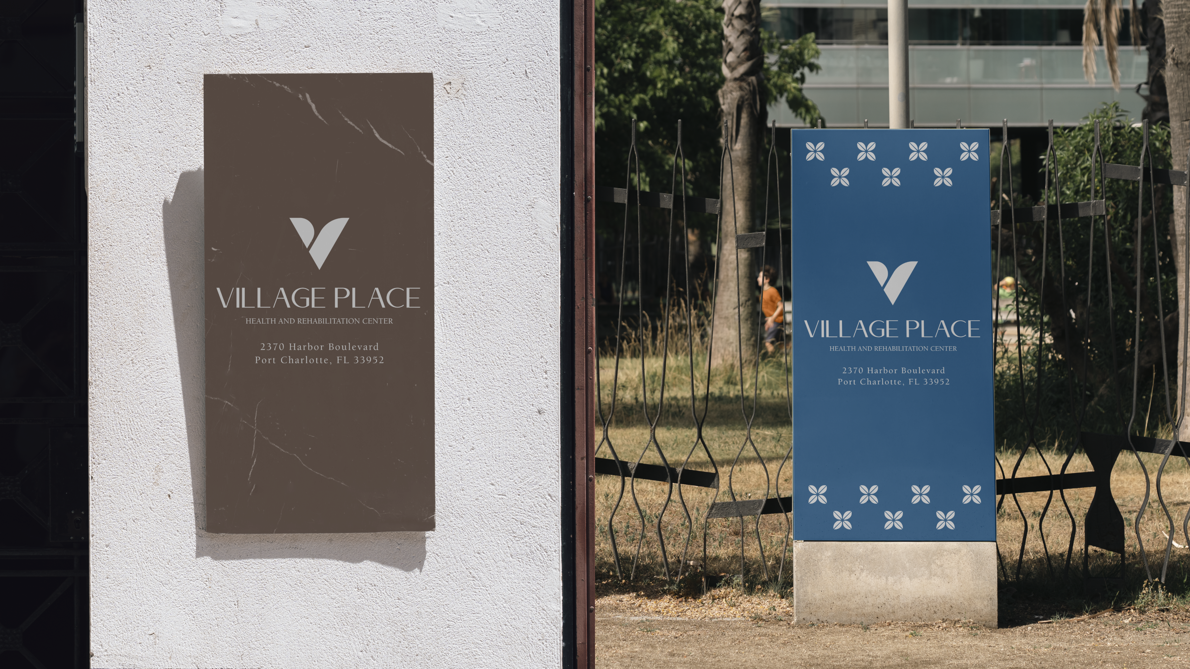 Village Place exterior monolith signs — brown wall plaque and blue freestanding marker with address